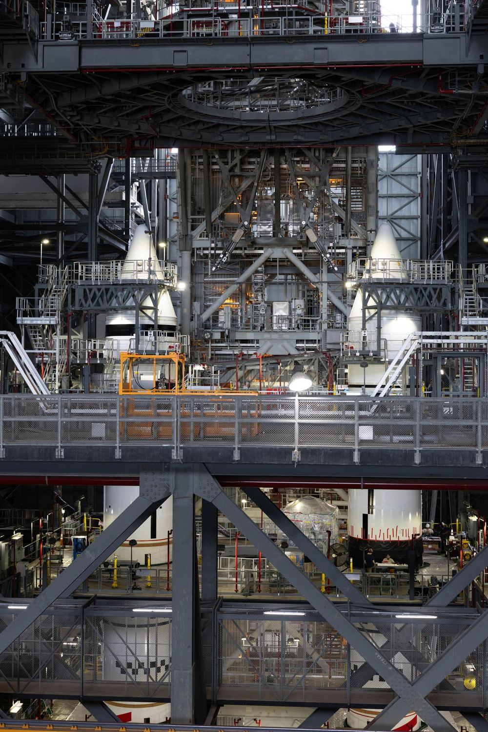 The twin white SLS solid rocket boosters stacked on the mobile launcher inside the Vehicle Assembly Building