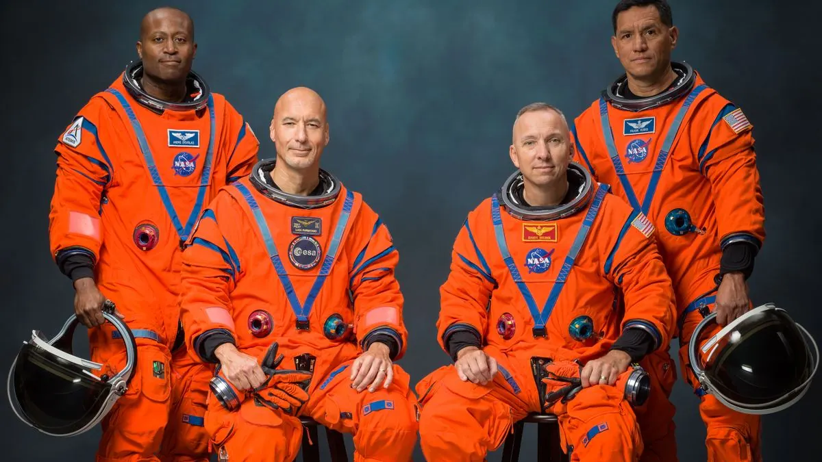 The four Artemis III astronauts in orange Orion Crew Survival System suits