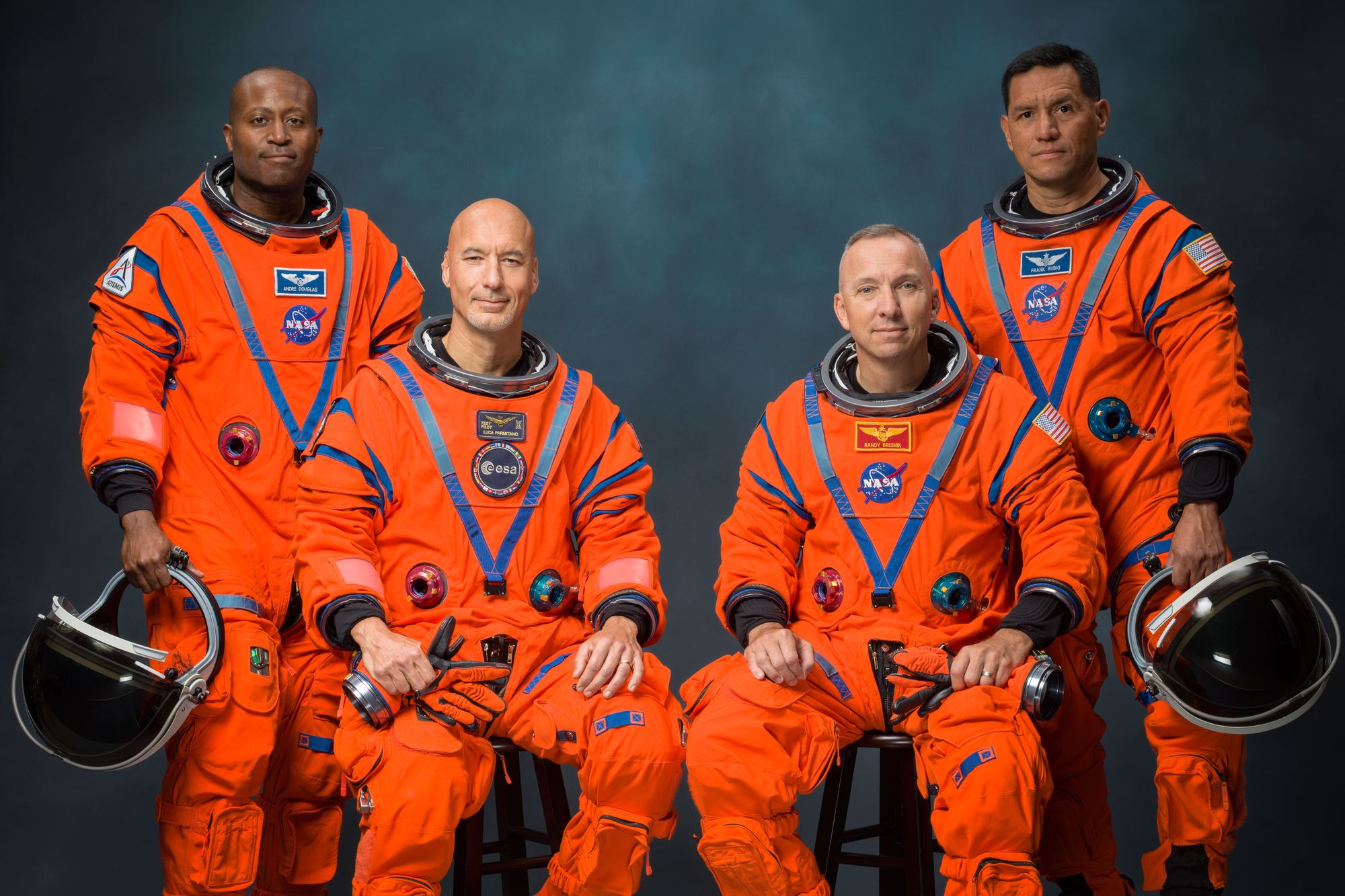 The Artemis III crew in orange Orion Crew Survival System suits: Andre Douglas, Luca Parmitano, Randy Bresnik and Frank Rubio