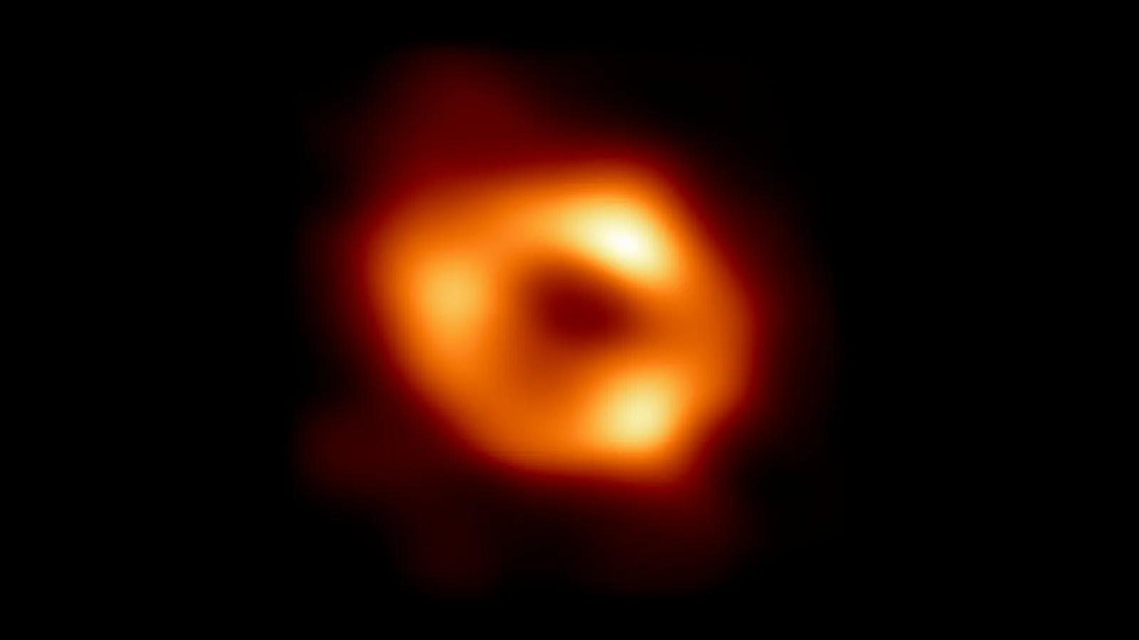 The Event Horizon Telescope image of Sagittarius A*: a blurry orange ring of glowing gas around a dark centre, on a black background