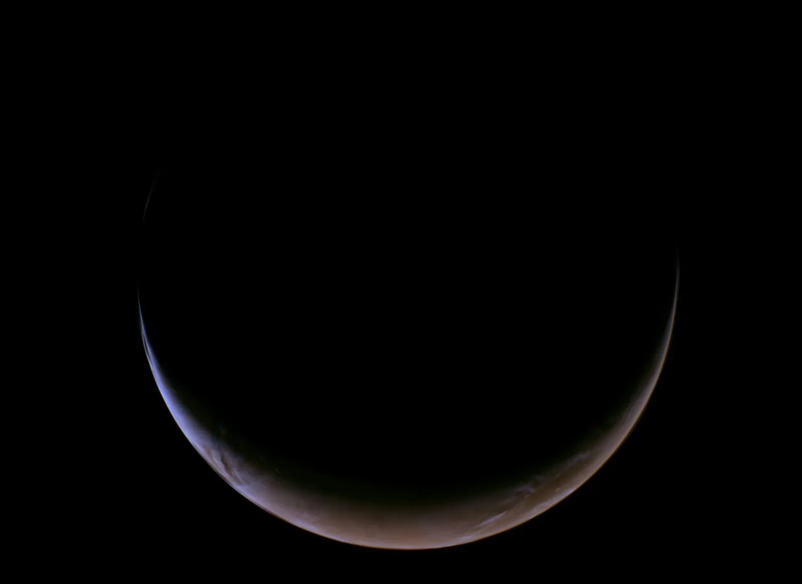 A thin, glowing crescent of Mars against black space, reddish-brown with a faint blue edge of atmosphere